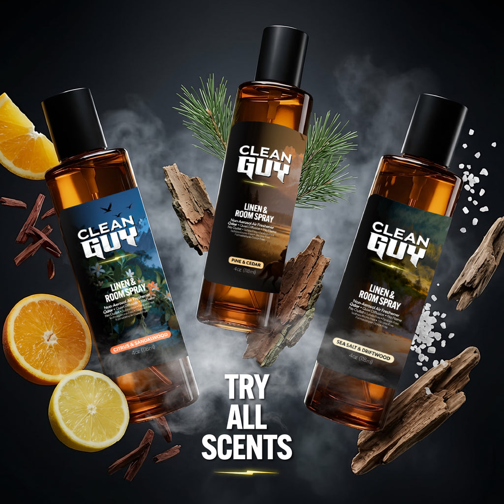 Three bottles of Clean Guy linen and room spray with decorative elements on a dark background.