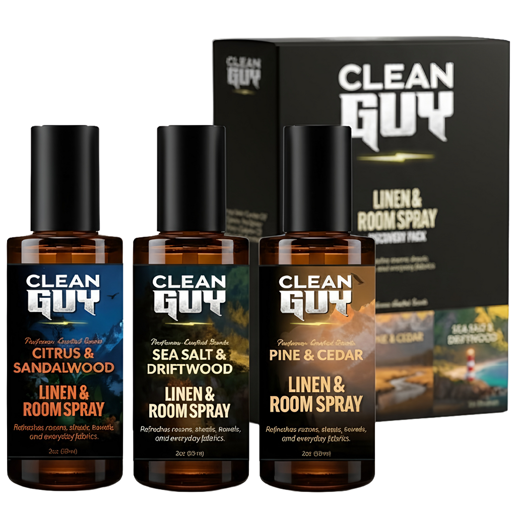 Three bottles of Clean Guy linen and room spray with packaging in the background.